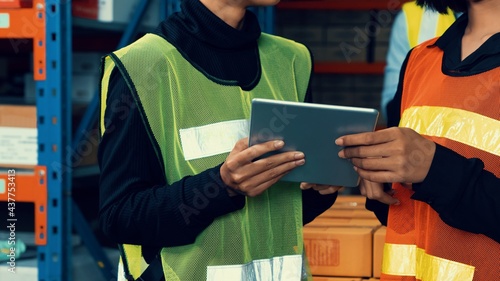 Female warehouse worker working at the storehouse . Logistics , supply chain and warehouse business concept . photo