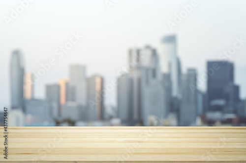 Blank table top made of wooden planks with beautiful blurry cityscape at daytime on background  mockup
