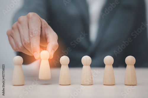 Man hand touch wooden Human resources officer looking for leader and CEO concept  Leader leave his comfort zone and get out of the crowd. Personal development  motivation and challenge.