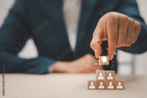 Businessman hand holding wood cubes with light bulb icon, HR Human and people icon,Technology Process System Business with Recruitment, Hiring, Team Building.Organisation structure concept.