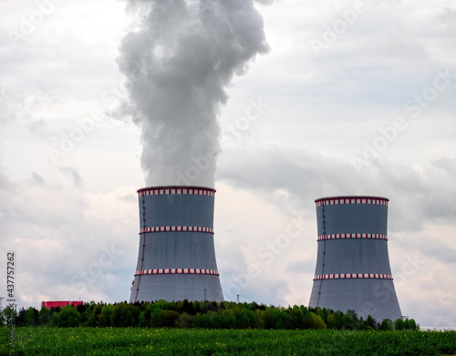 Two cooling towers close-up of nuclear power plant against the cloudy dramatic sky in Ostrovets, Grodno region, Belarus. photo