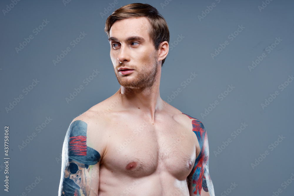 man with tattoo naked torso sport fitness gray background portrait