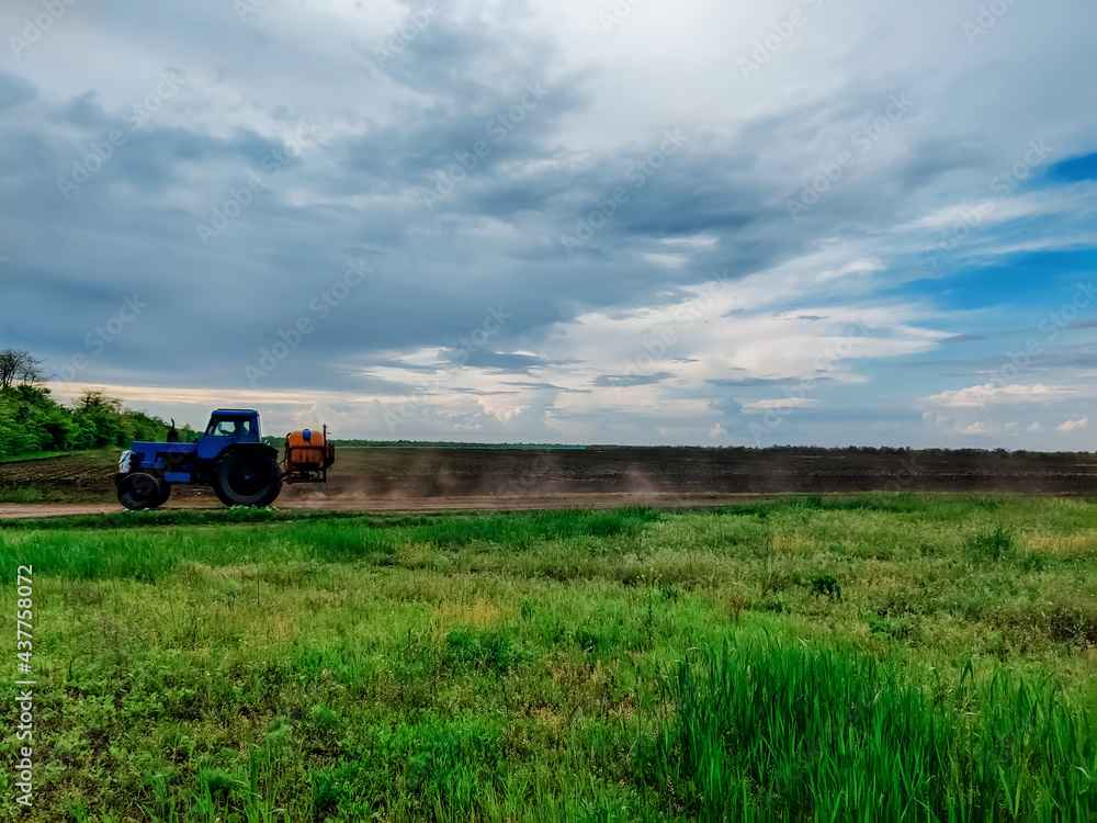 Fototapeta premium tractor on the background of the field