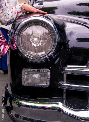 Retro car festival. Retro car headlight. Fragment of the front of a retro car.