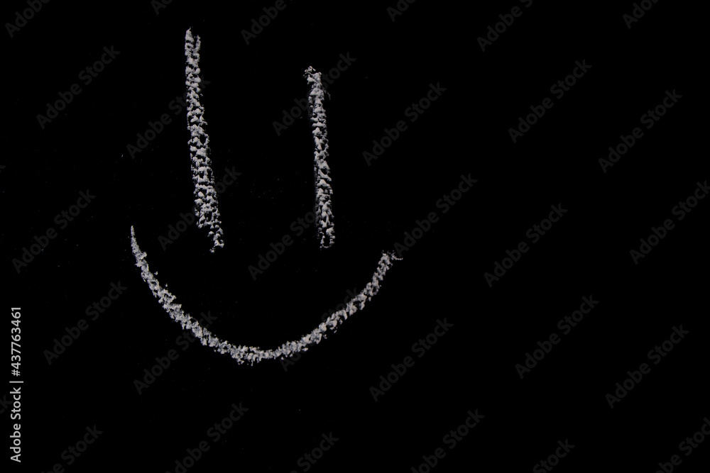 A close up of a smiling face on a chalk board A close up of a smiling face on a chalk board