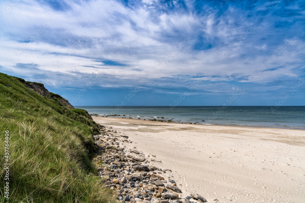 beautiful white sand beach with high grassy sand dunes behind beautiful white sand beach with high grassy sand dunes behind