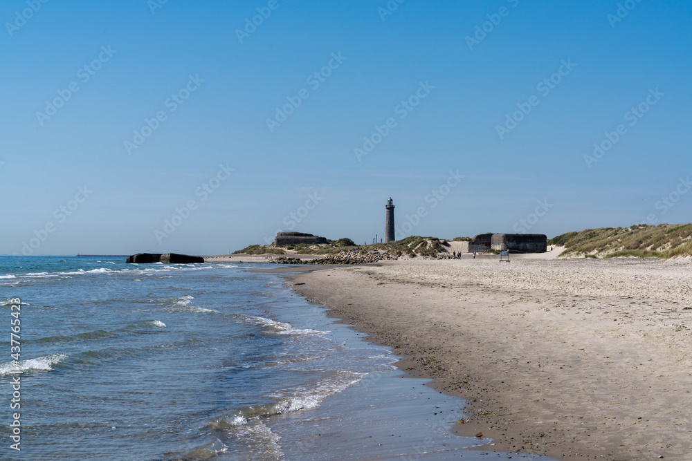 old bunkers on the beaches at Skagen in north Denmark with the lighthouse in the background