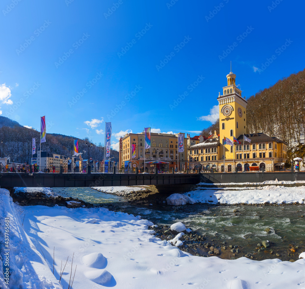 Russia, Krasnodar Region, Krasnaya Polyana, Esto-Sadok, Winter. Hotels on the banks of the Mzymta River, Bridge and flags
