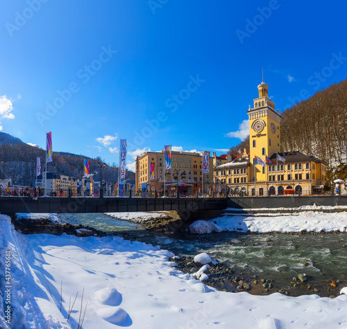 Obraz na płótnie Russia, Krasnodar Region, Krasnaya Polyana, Esto-Sadok, Winter. Hotels on the banks of the Mzymta River, Bridge and flags w salonie
