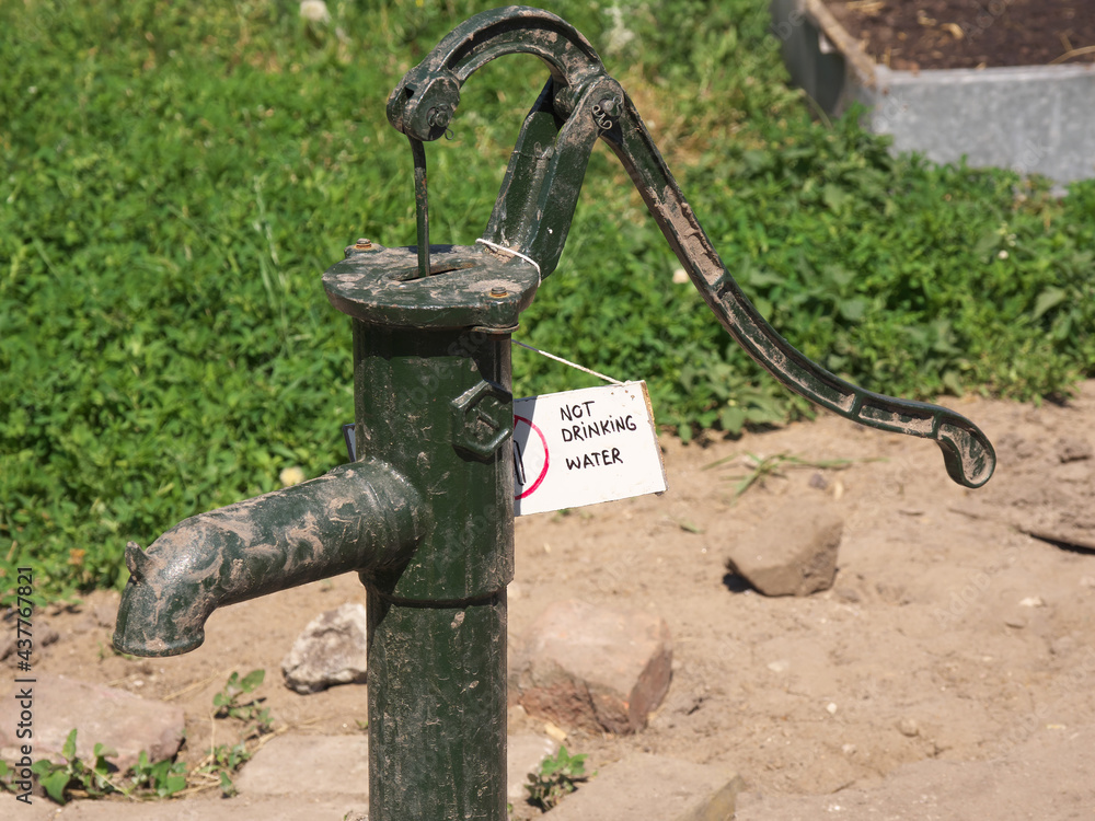 Manual mechanical column. Lettering on the poster: NOT DRINKING WATER Manual mechanical column. Lettering on the poster: NOT DRINKING WATER