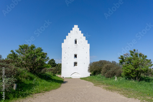 view of the Der Tilsandede Kirke church near Skagen buried in the sand dunes and vegetation