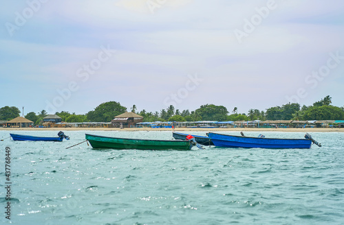 fisherman sails on a motor boat in the bay photo