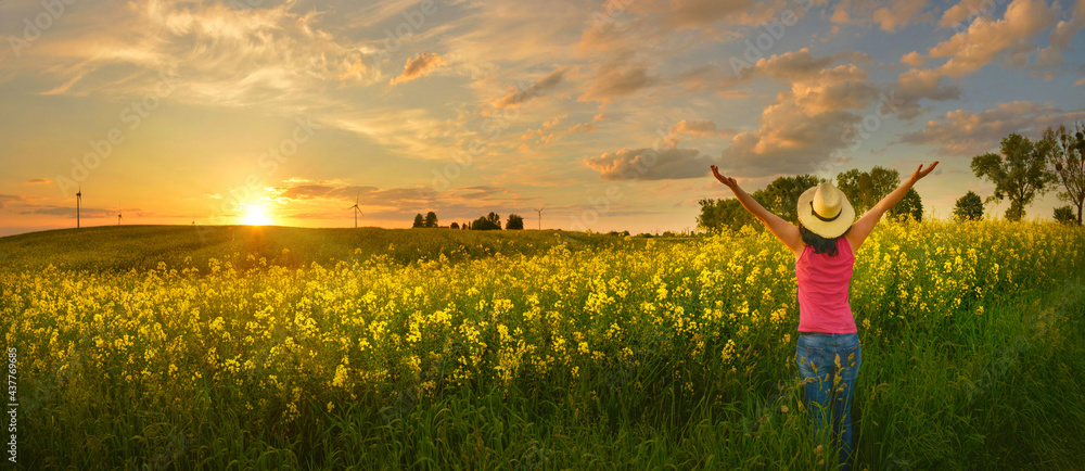 Happy woman enjoys beautiful sunset on flower field Happy woman enjoys beautiful sunset on flower field