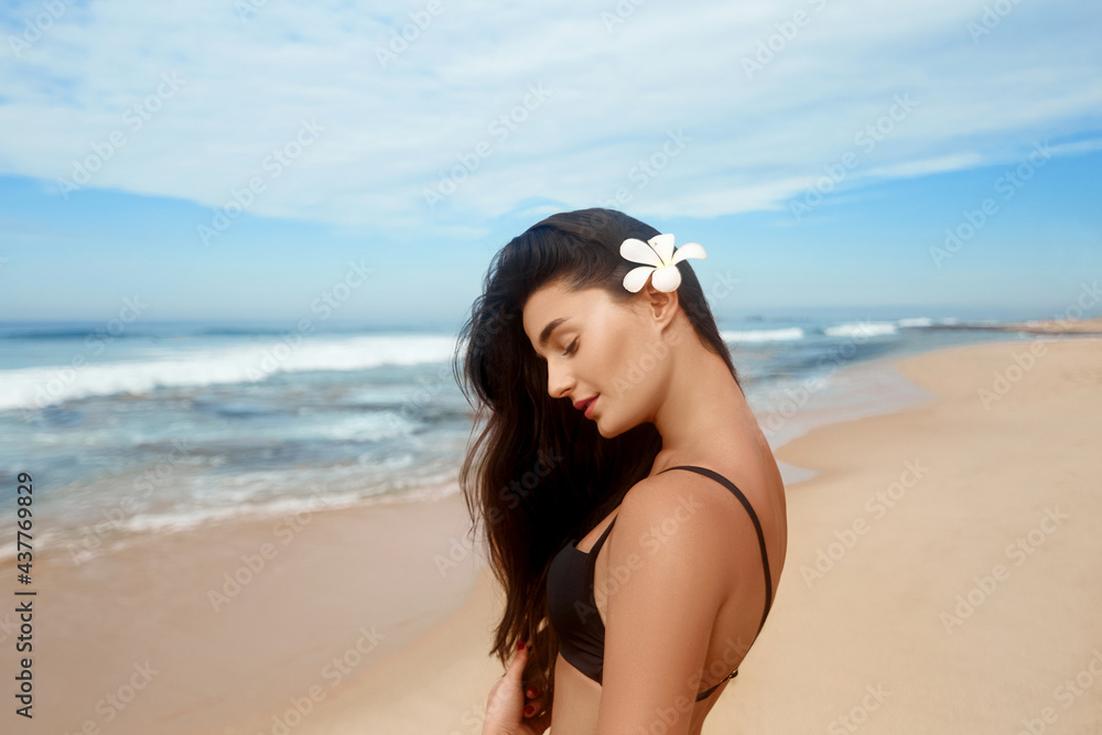 Portrait of fashion young girl with tanned sexy body. Beautiful woman in black bikini on tropical beach. Skine care Portrait of fashion young girl with tanned sexy body. Beautiful woman in black bikini on tropical beach. Skine care