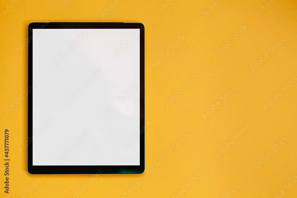 Tablet screen mockup isolated on yellow background, top view Tablet screen mockup isolated on yellow background, top view