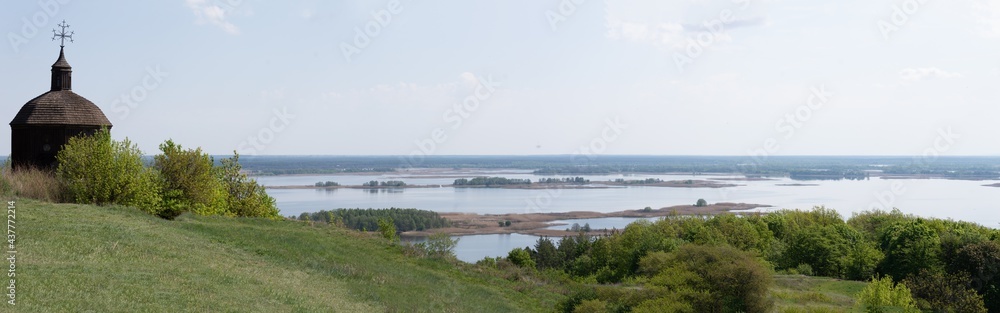 Panorama of Dnieper with old wood church in Vytachiv, Ukraine on May 3, 2020.