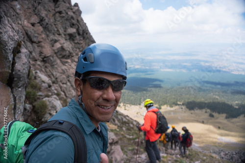 A smiling Hispanic hiker enjoying the beautiful view at the Malinche Volcano in Mexico