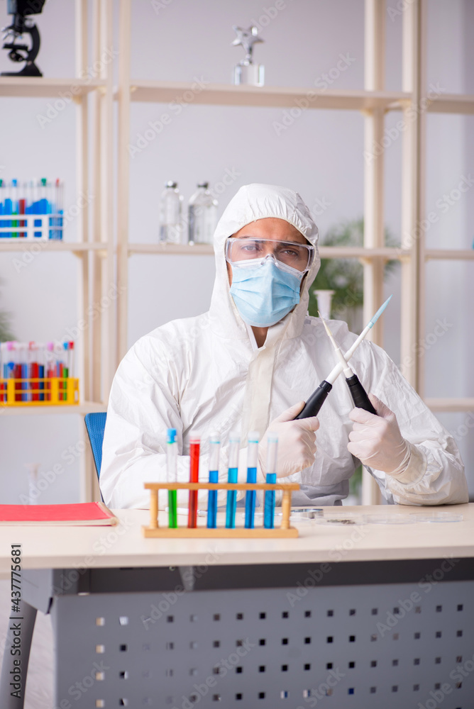 Young male chemist working at the lab during pandemic Young male chemist working at the lab during pandemic