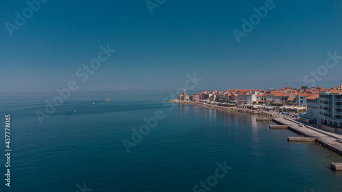 Aerial panorama of picturesque city of Piran at the heart of Slovenian istria on a sunny day. Calm sea and blue skies.