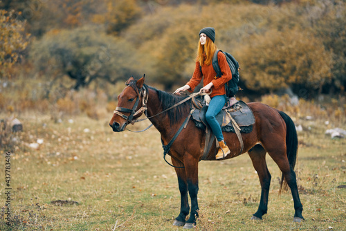 woman hiker in the mountains riding a horse travel lifestyle © SHOTPRIME STUDIO