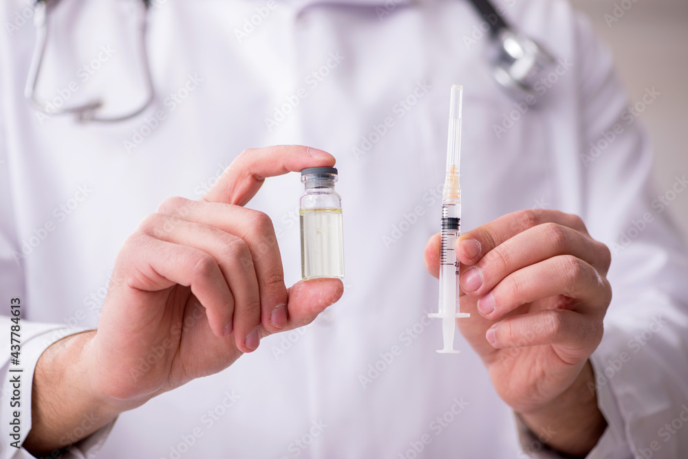 Young male doctor in vaccination concept Young male doctor in vaccination concept