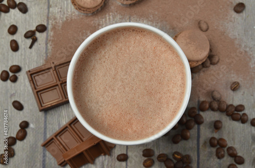 Top view of Latte hot coffee (or cappuccino) roasted coffee beans and ingredients on wooden table