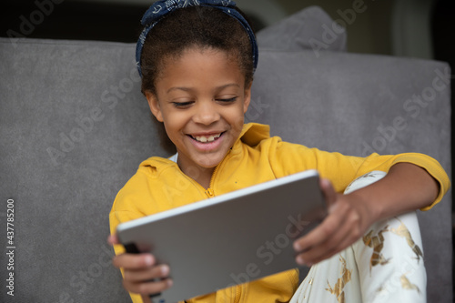 Girl playing games online on a tablet