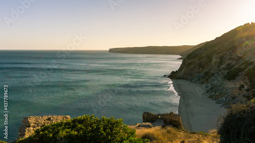 Coastline at Praia da Figueira from above the cliff with view at the beach below during sunset, Figueira, Portugal