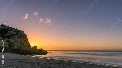Colorful sky at morning with rock before sunrise at praia da Figueira, Portugal