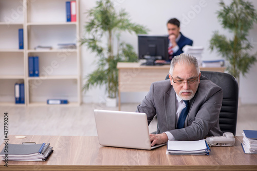 Two male employees working in the office