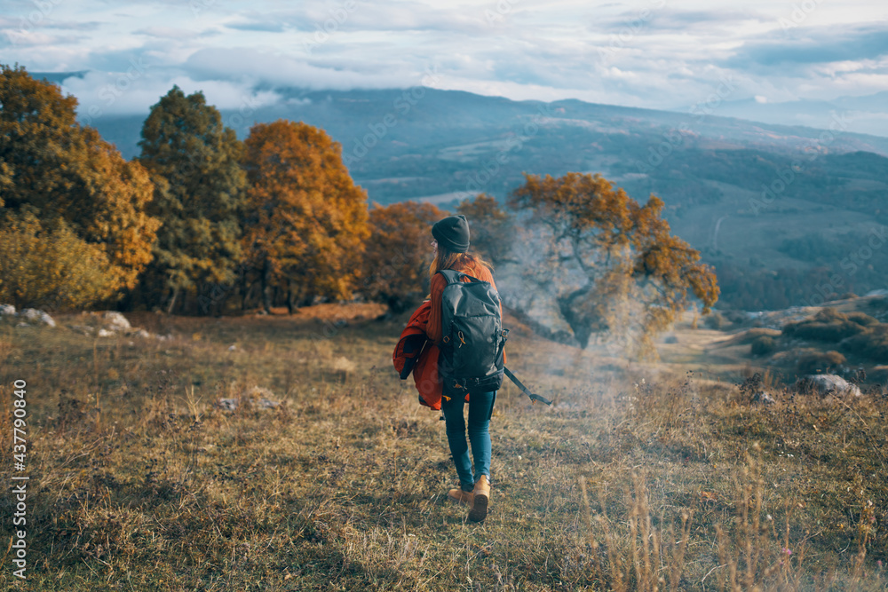 woman hiker with backpack travel autumn trees mountains landscape