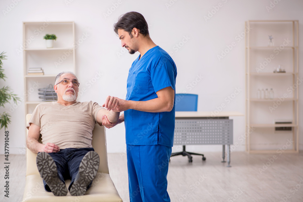 Old male patient visting young male doctor Old male patient visting young male doctor