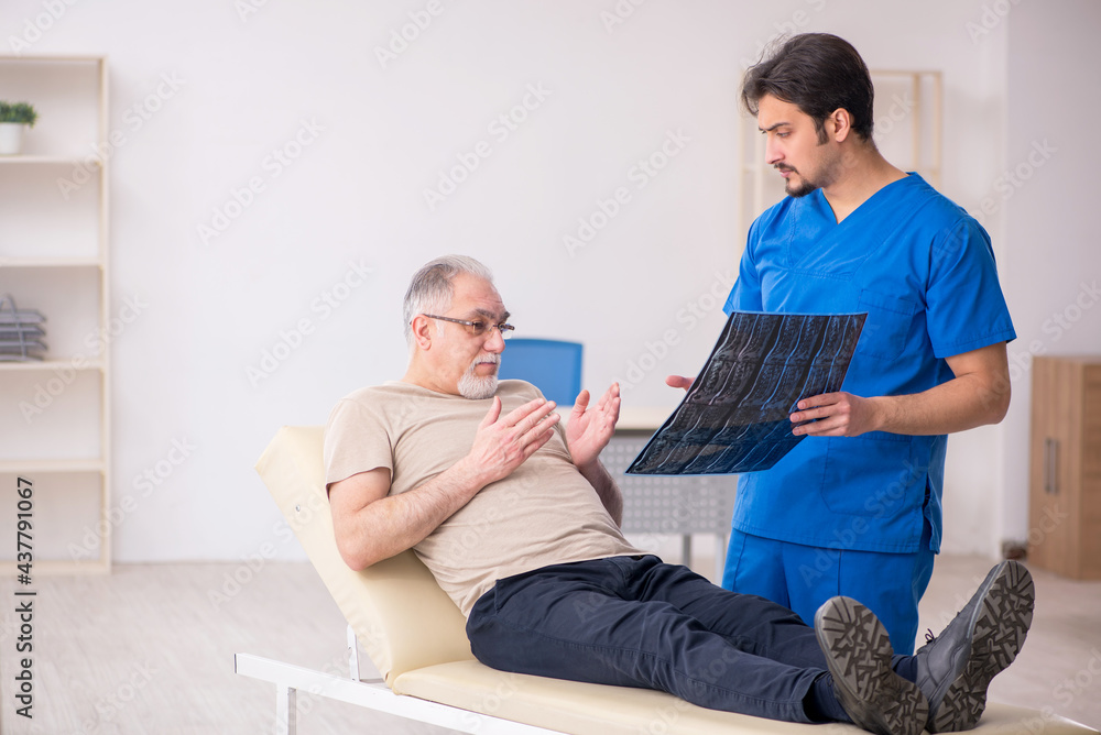 Obraz premium Old male patient visting young male doctor radilogist