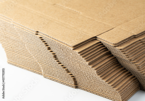 A lot of pre-assembled cardboard boxes stacked on a white background. photo