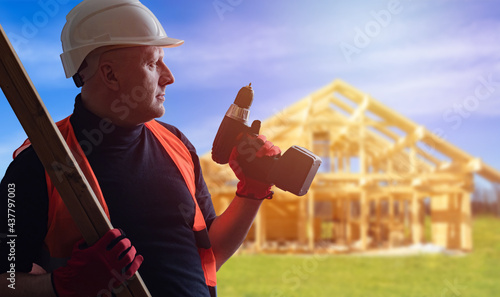 Builder in front of frame o...
