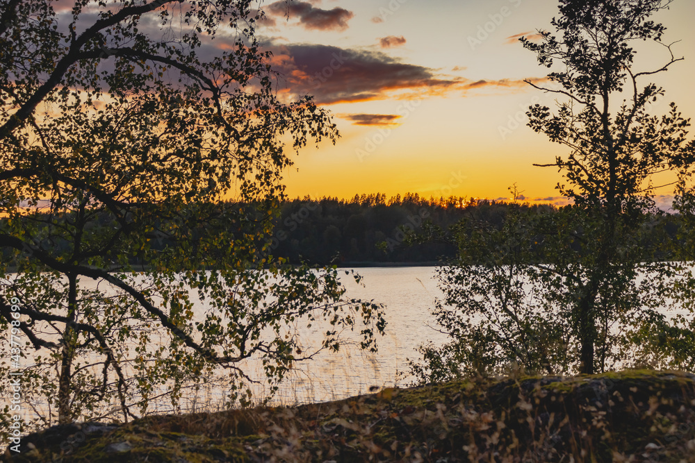 Sunset on a lake with rocky shores in Karelia Sunset on a lake with rocky shores in Karelia