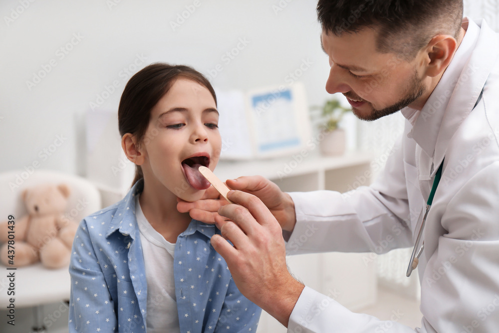 Pediatrician examining little girl in office at hospital Pediatrician examining little girl in office at hospital