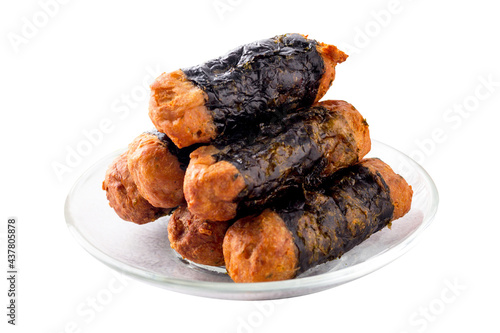 Seaweed Chicken Roll are stacked on a glass plate isolated on a white background.
