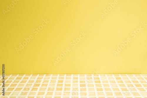 Obraz na płótnie Yellow ceramic mosaic tile table. yellow wall background. Home interior w salonie