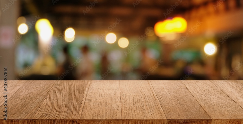 Empty wooden table in front of abstract blurred background of coffee shop . can be used for display or montage your products.Mock up for display of product.