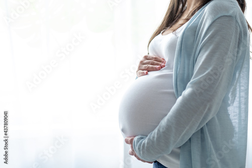 healthy pregnancy. Side view pregnant woman with big belly advanced pregnancy in hands. Banner copyspace for text. Elegant mother waiting baby