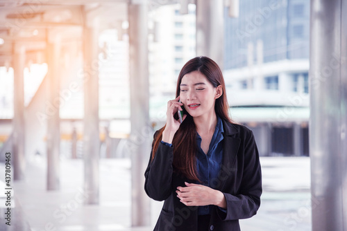 Business woman using smartphone shopping online  call  texting message internet technology lifestyle. Asian woman using cellphone walking on city street. Smart phone smart confident woman modern city