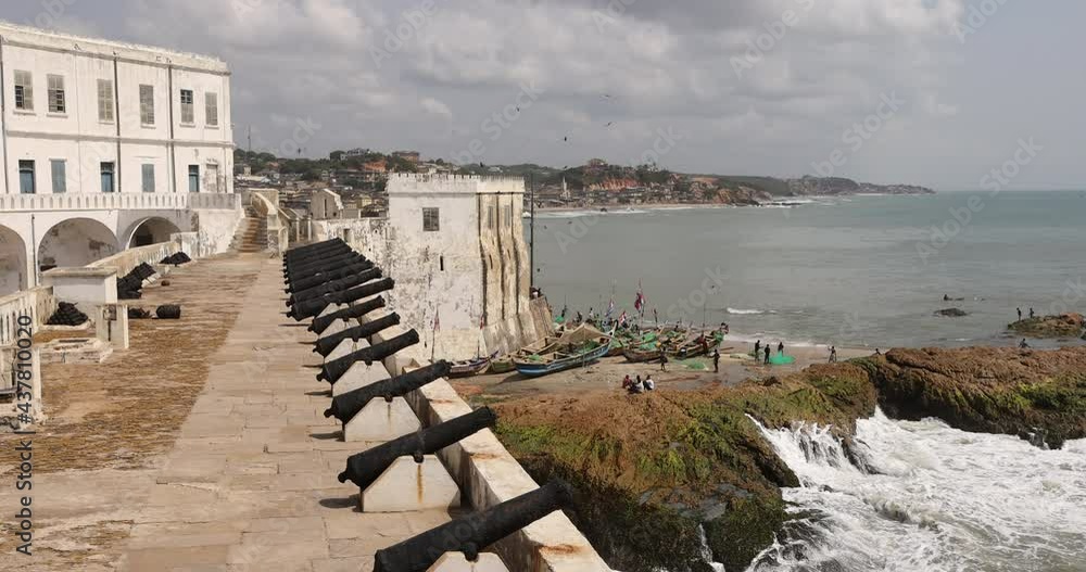 Cape Coast castle canon wall fishing boats Ghana 4K. Slave castles or fort on the Gold Coast of West Africa by European traders. Millions of African slaves passed through here. Cape Coast castle canon wall fishing boats Ghana 4K. Slave castles or fort on the Gold Coast of West Africa by European traders. Millions of African slaves passed through here.