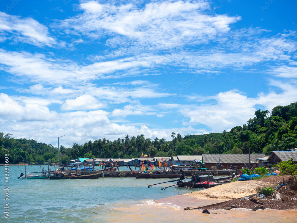 Beautiful seascape summer background. Scene of fisherman village with many local longtail boat on the sea and sky background on a sunny day in Thailand.