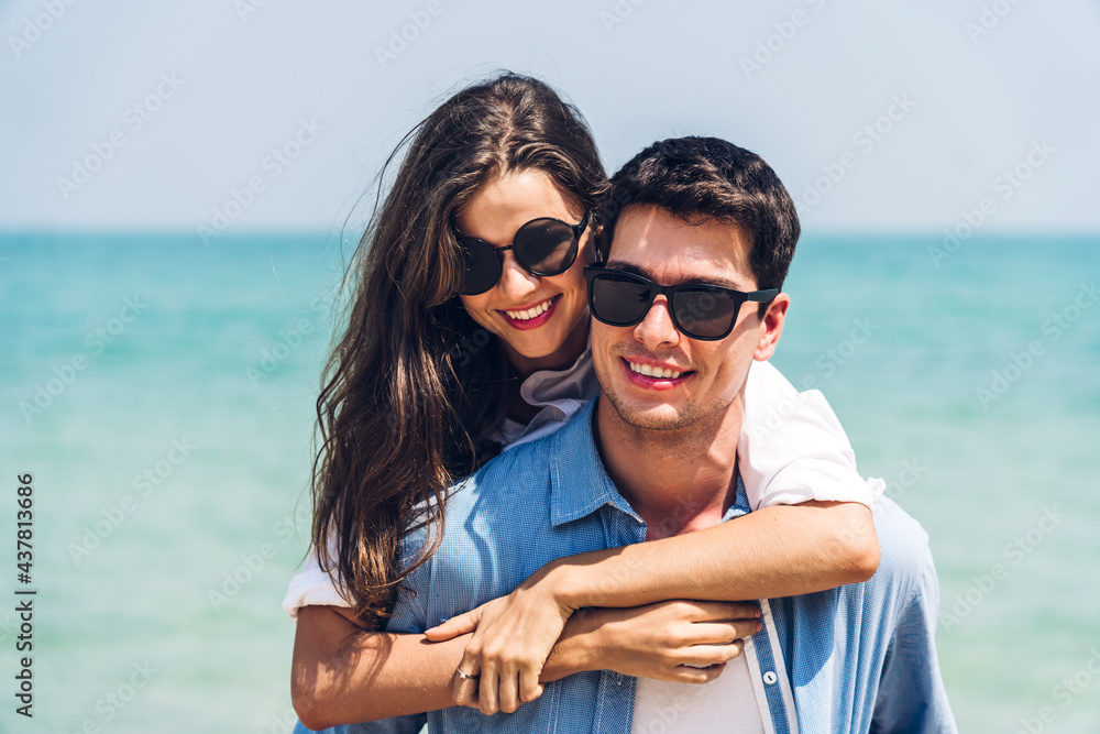 Vacation romantic lovers young happy couple hug and standing on sand at sea having fun and relaxing together on tropical beach.Summer travel