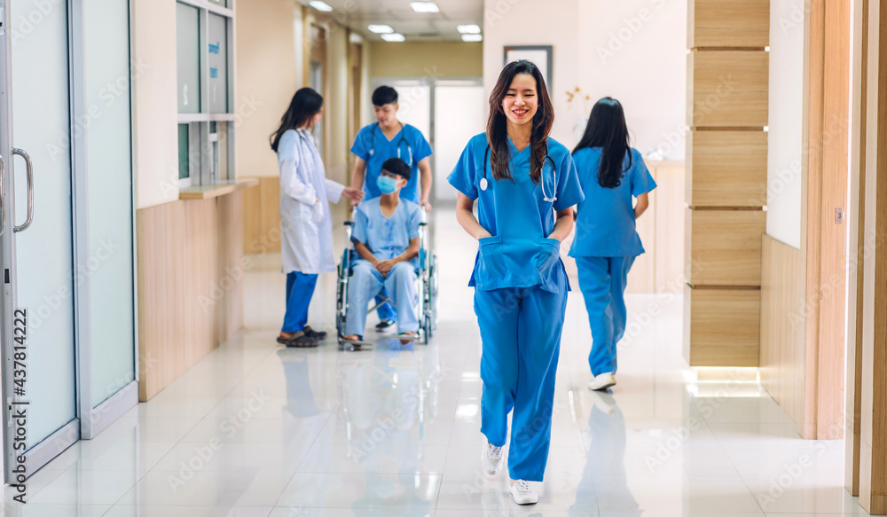 Group of professional medical doctor team with stethoscope in uniform working discussing and talk walking in hospital.health medical care concept Group of professional medical doctor team with stethoscope in uniform working discussing and talk walking in hospital.health medical care concept