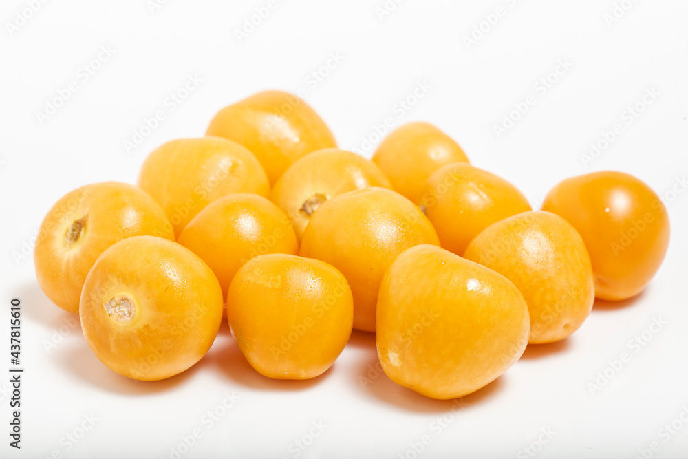 Bunch of bright yellow ripe Cape goldenberries isolated on white background. Macro photography. Bunch of bright yellow ripe Cape goldenberries isolated on white background. Macro photography.