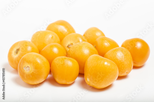 Bunch of bright yellow ripe Cape goldenberries isolated on white background. Macro photography.