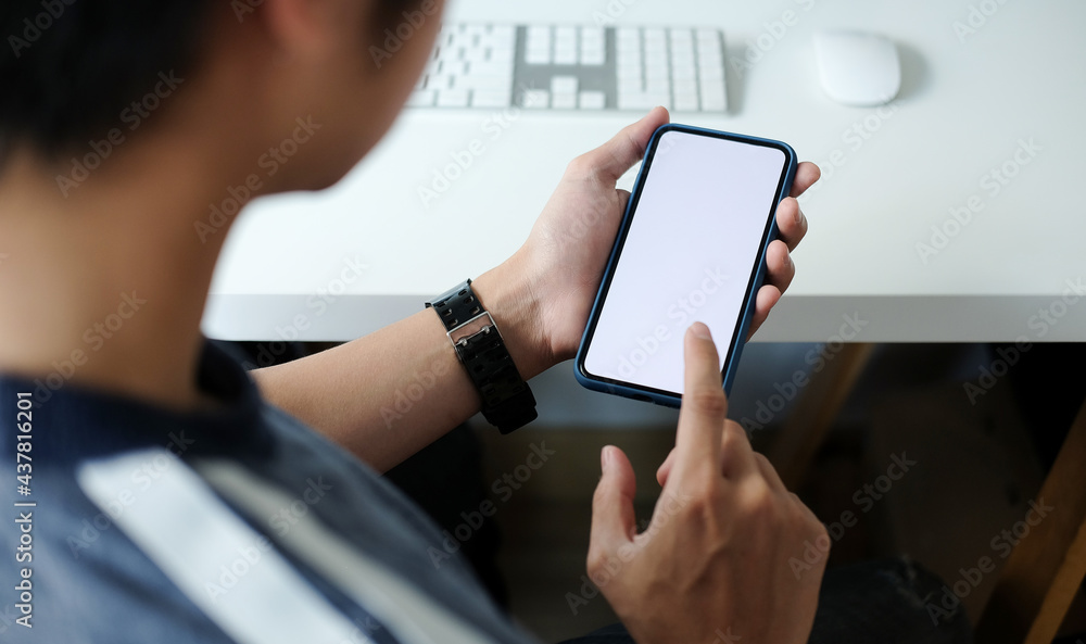 Close up view of businessman holding mock up smart phone with blank screen. Close up view of businessman holding mock up smart phone with blank screen.