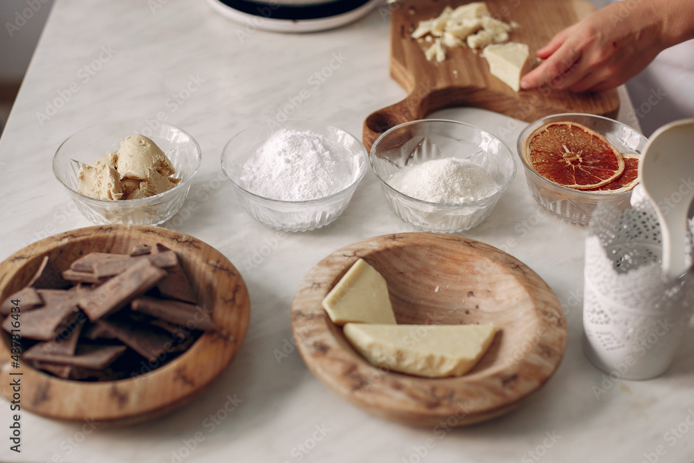 Confectioner cuts chocolate on a wooden board. Confectioner cuts chocolate on a wooden board.